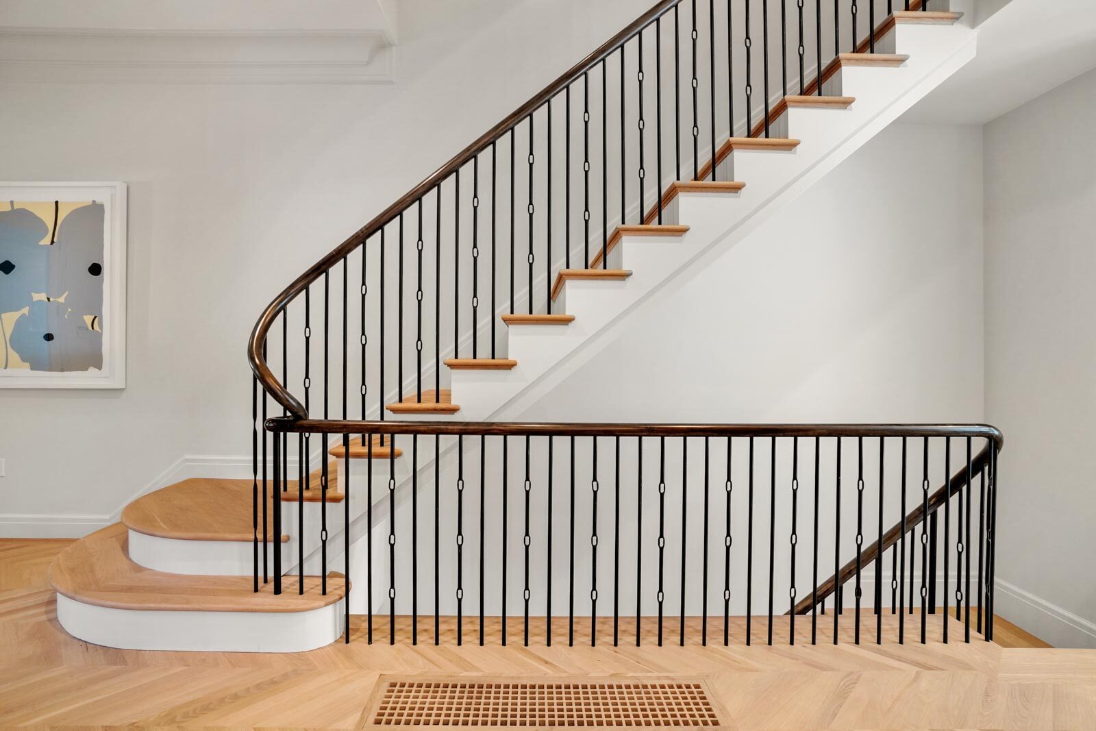 Staircase with painted trim and railing