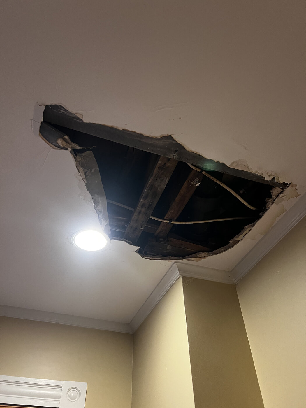 Ceiling with hole from water damage before repair